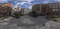 a street view in a spherical lens with buildings and benches around it that have been painted