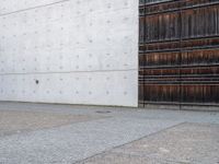 a man is standing next to an open building and holding a skateboard with a ball on it