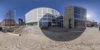 the 360 - view image of an outside building, with a bus parked by the street side