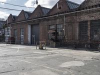 three bicycles parked outside an old brick building by a sidewalk with several steps in it