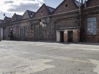 three bicycles parked outside an old brick building by a sidewalk with several steps in it