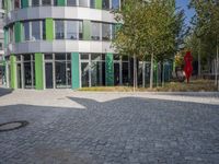 large boulders sit in front of a building with many glass doors and windows on one side