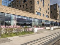 there is a picture of a restaurant outside the building that is surrounded by grass and trees