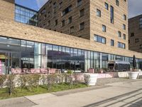 there is a picture of a restaurant outside the building that is surrounded by grass and trees