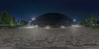 a 360 - cam image of a building at night with lights lit up and reflecting off the bricks