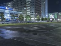 view of a street that has cars parked in front of it at night with lights on