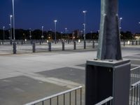 a parking lot that has several lights on it's side, the pole is slightly empty