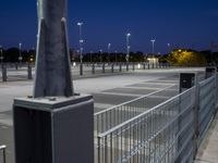 a parking lot that has several lights on it's side, the pole is slightly empty