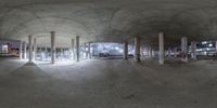 an artistic photo of an empty parking garage in the city at night time, with a couple cars on the right and another vehicle in the back