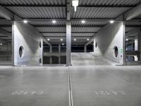 a garage with an empty parking lot filled with metal equipment and signs at night time