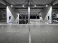 a garage with an empty parking lot filled with metal equipment and signs at night time