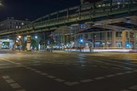 a night time photo of traffic, street and bridge in the city of a city