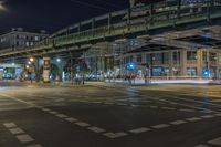 a night time photo of traffic, street and bridge in the city of a city