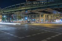 a night time photo of traffic, street and bridge in the city of a city