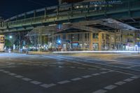 a night time photo of traffic, street and bridge in the city of a city