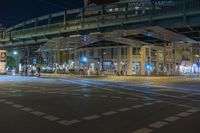 a night time photo of traffic, street and bridge in the city of a city