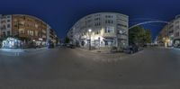 the fish eye lens reflects an image of a city intersection in a night time scene