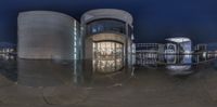 an image of a reflection of architecture in the water of a fountain at night time