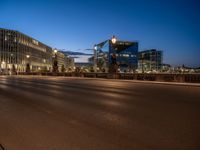 the city skyline is at night from the street level with traffic and pedestrians walking on it