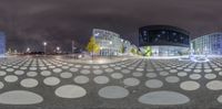 a spherical photograph of city and buildings in the background is a night sky with stars