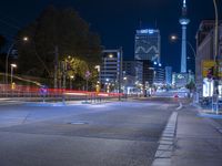 an empty street is pictured with the lights on as night approaches over town in berlin