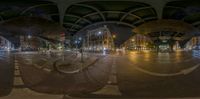 fish eye lens of a busy street at night with cars and people in the distance