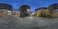 a reflection of a house on a street in the evening time, taken with a fish eye lens