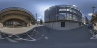 a virtual view of a traffic intersection where vehicles drive past it and go to another building