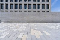 a stone floor in front of an office building with windows that says fedurm