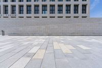 a stone floor in front of an office building with windows that says fedurm