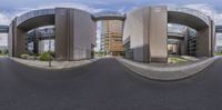 three circular buildings on a residential street in the middle of a city area with large windows