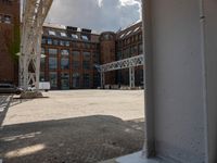 an outdoor courtyard with many large brick buildings and a skylight over it's area