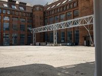 an outdoor courtyard with many large brick buildings and a skylight over it's area