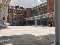 an outdoor courtyard with many large brick buildings and a skylight over it's area