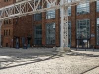 an outdoor courtyard with many large brick buildings and a skylight over it's area