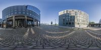 two circular panoramic images in a building next to an intersection of a street and parking