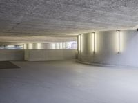 this image shows a circular empty room filled with concrete space and several doors opened in the corner