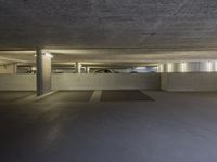 this image shows a circular empty room filled with concrete space and several doors opened in the corner