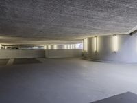 this image shows a circular empty room filled with concrete space and several doors opened in the corner