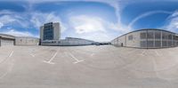 this is a 360 - view image of an empty parking lot outside a large building