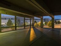 an empty parking garage with no windows at night, overlooking the airport walkways and cars