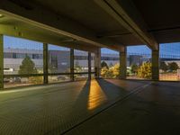 an empty parking garage with no windows at night, overlooking the airport walkways and cars