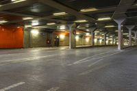 this is an underground city space with some lights on the ground and bricked concrete floors