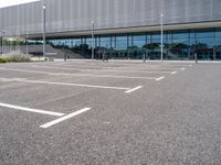 the parking lot near the building is empty for everyone to see in its picture,