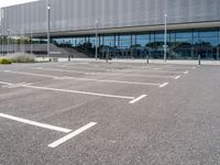 the parking lot near the building is empty for everyone to see in its picture,