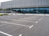 the parking lot near the building is empty for everyone to see in its picture,