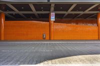 the orange tiles of a parking lot cover this entrance and keep people away from driving