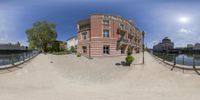 an 360 - view image of a walkway with bushes in front of an apartment building