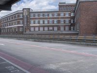 a building that has some windows next to it with graffiti on it in an empty road