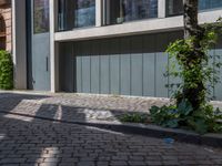 a city street that has a sidewalk, trees and a curb on both sides of the road